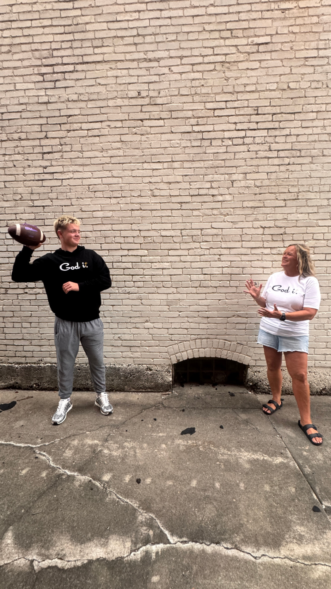 Tossing a football in God it. hoodie and tee