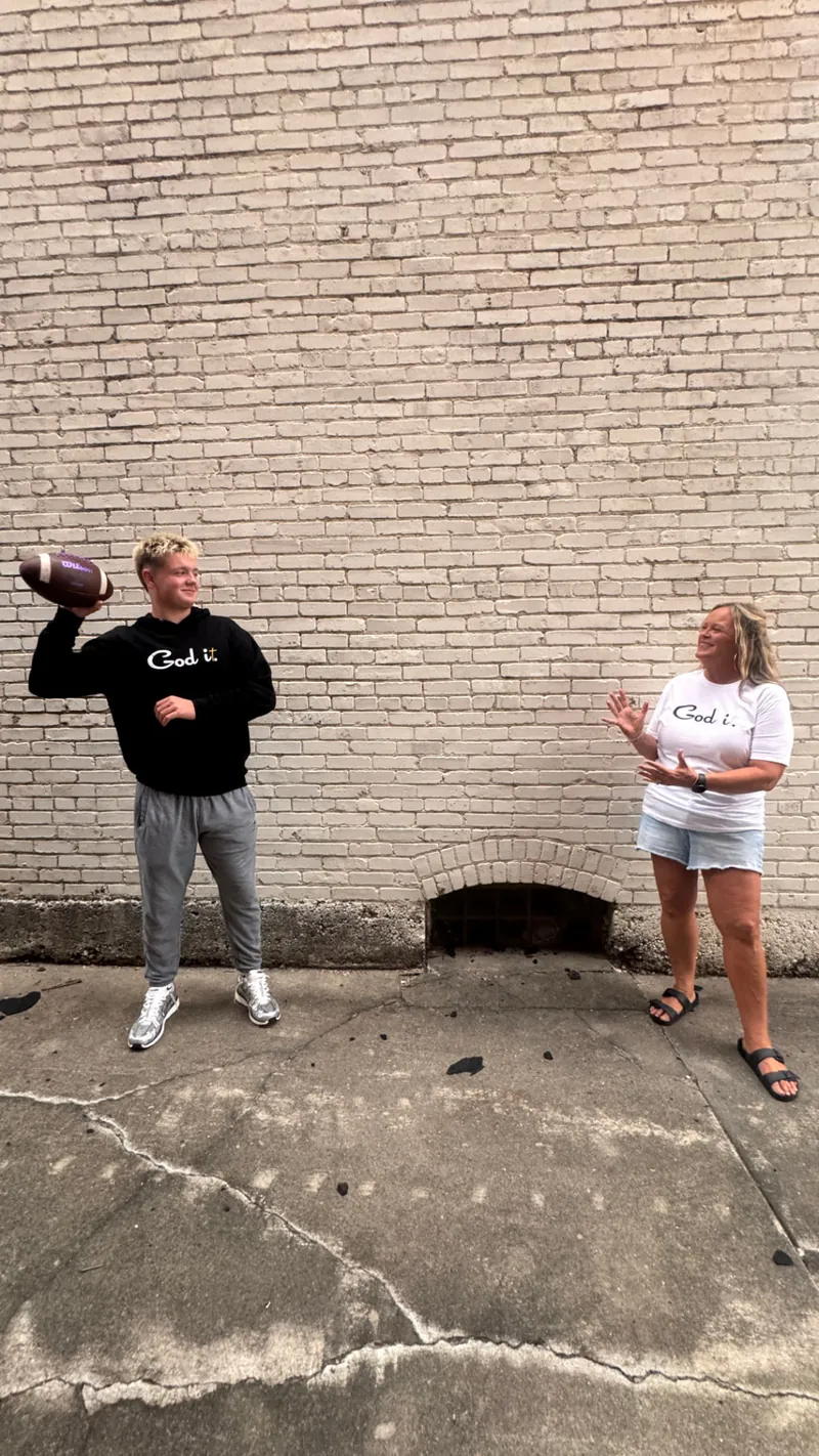 Tossing a football in God it. hoodie and tee