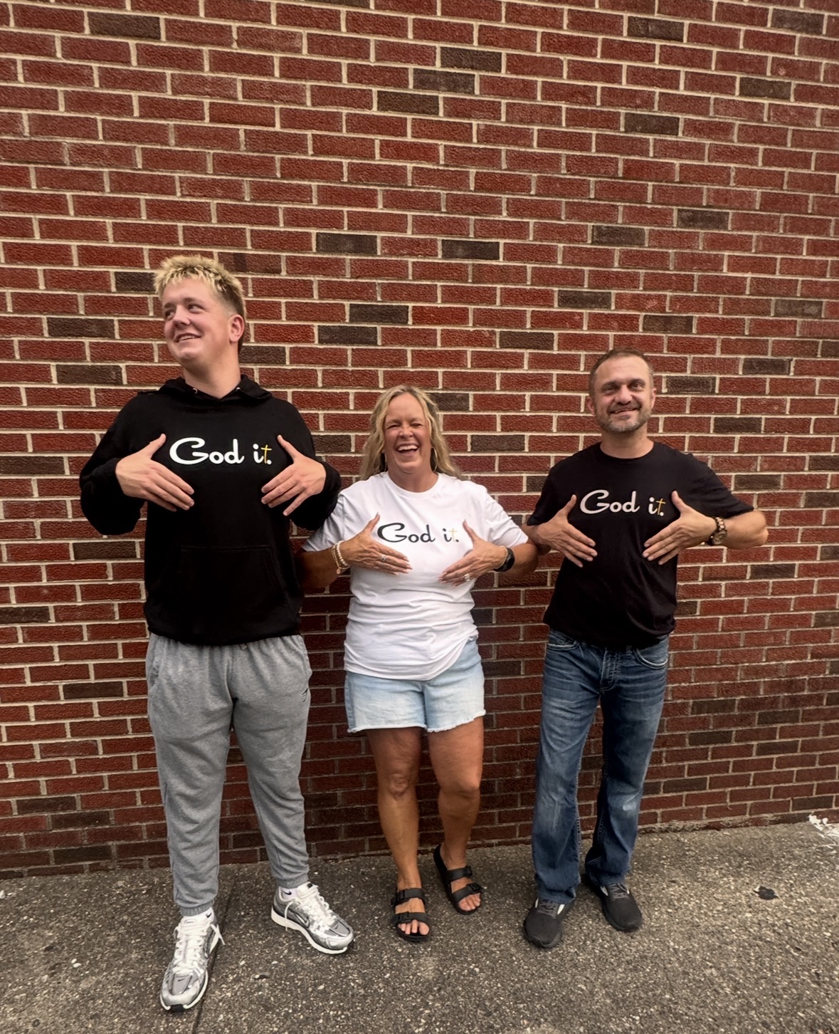 Family of three pointing at their God it. shirts